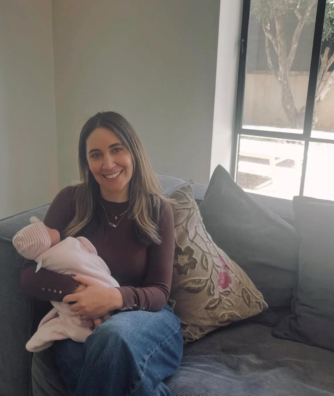Sarie Klein, certified childbirth educator and lactation consultant, holding her newborn